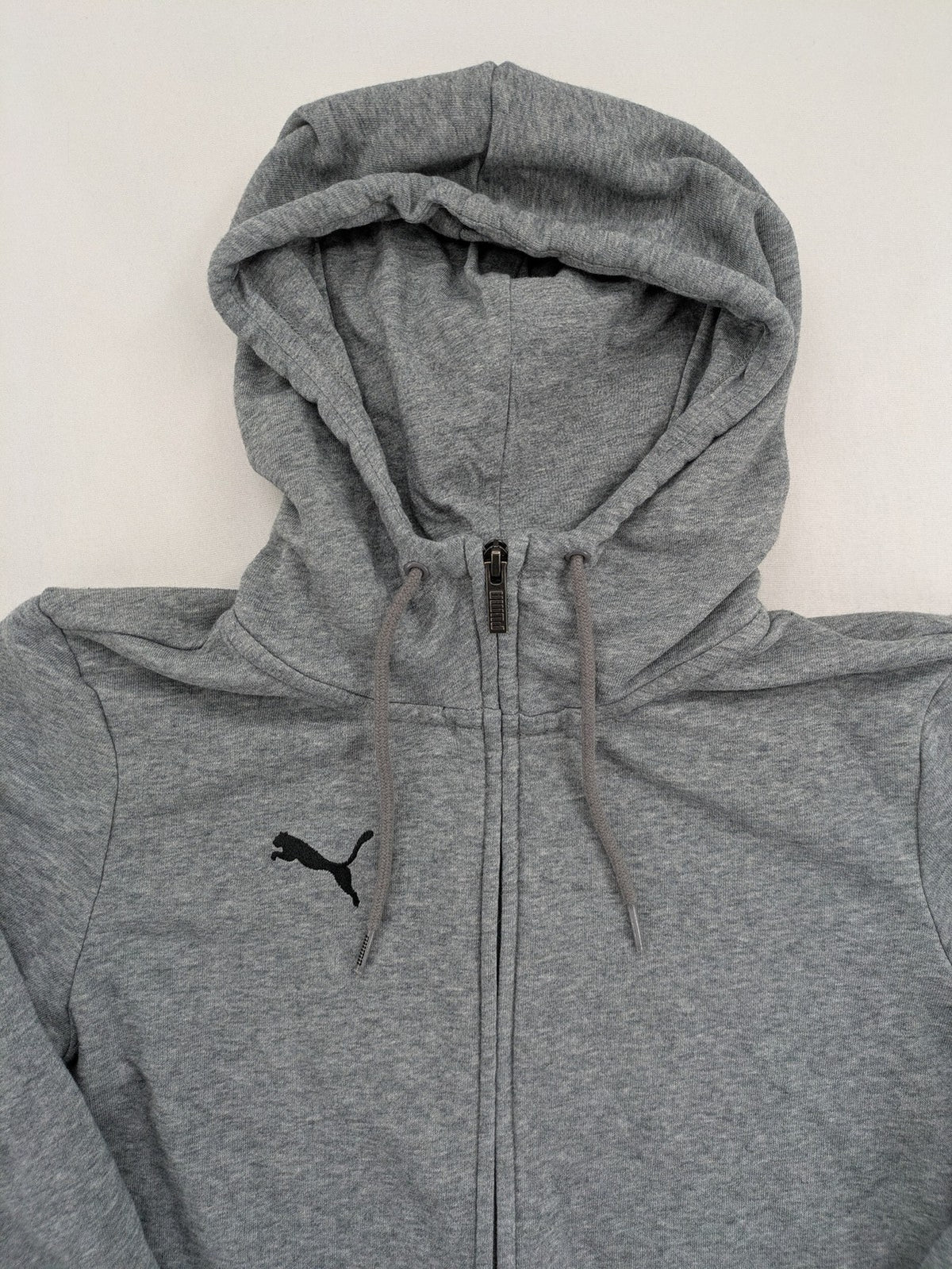 Puma grey full zip hoodie with adjustable drawstring hood and logo detail.