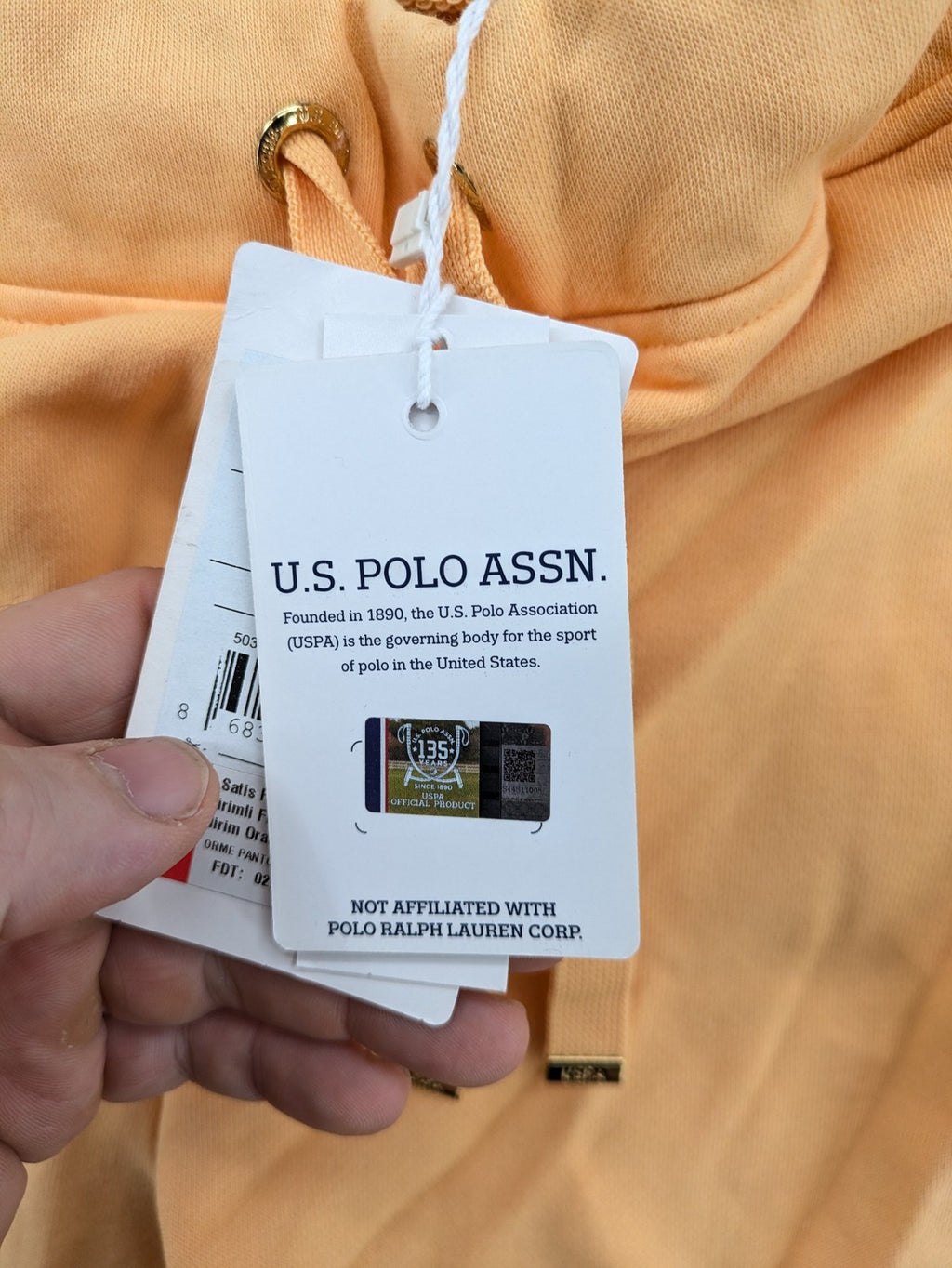 U.S. Polo Assn. orange sweatpants slim fit with sequin USPA logo on leg.