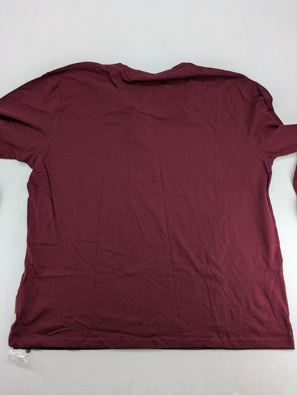 Jan Vanderstorm burgundy Henley shirt with button placket and "087 JV DEPT" graphic print.