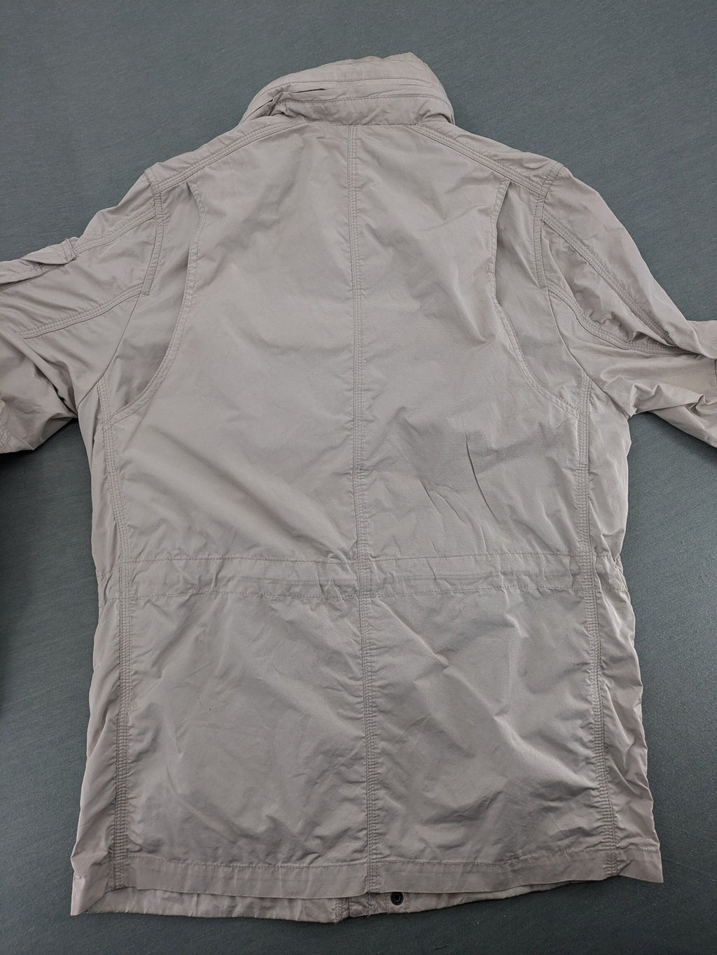 Camp David beige field jacket with logo patches, standing collar, and multiple pockets.