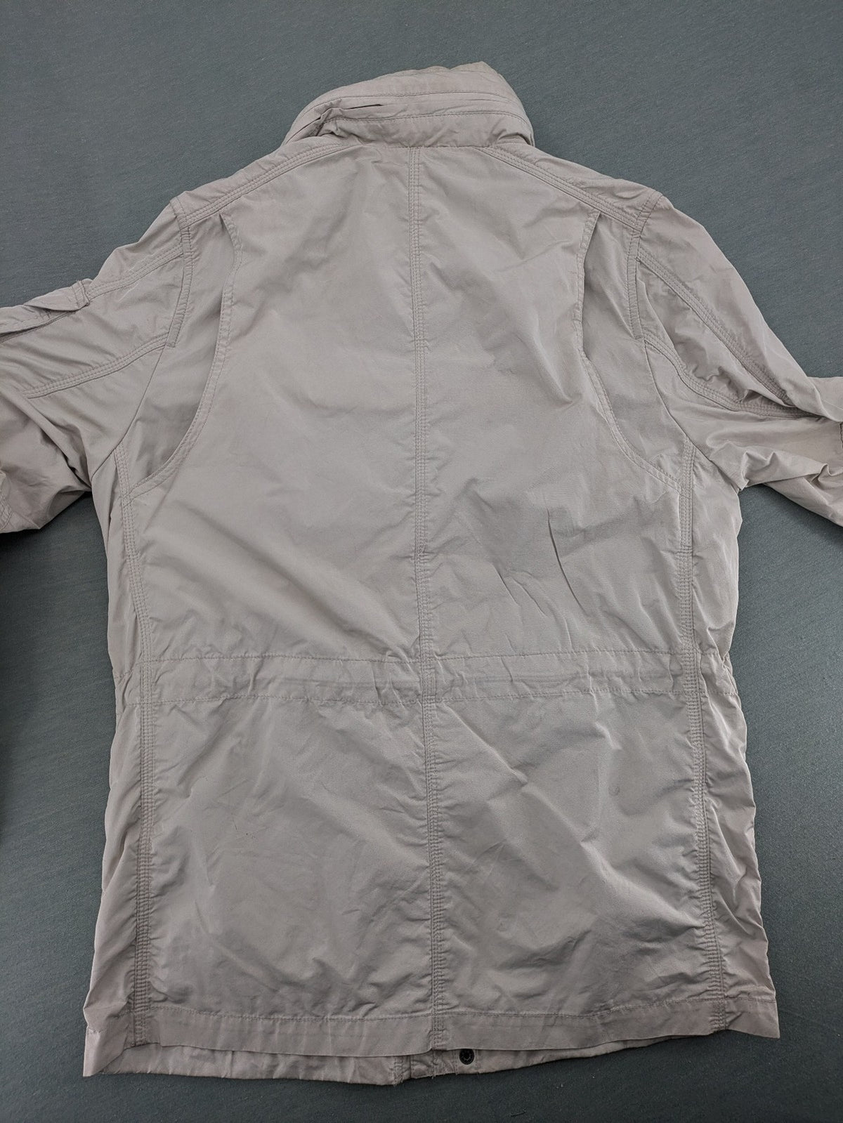 Camp David beige field jacket with logo patches, standing collar, and multiple pockets.