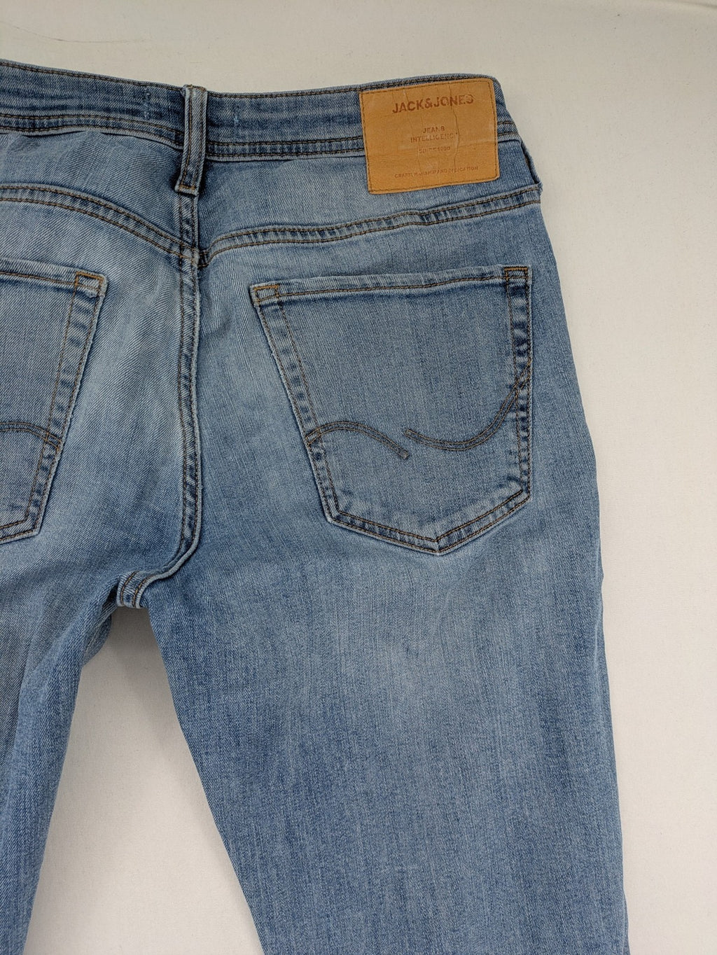 Jack & Jones blue slim jeans with button fly and subtle used look.