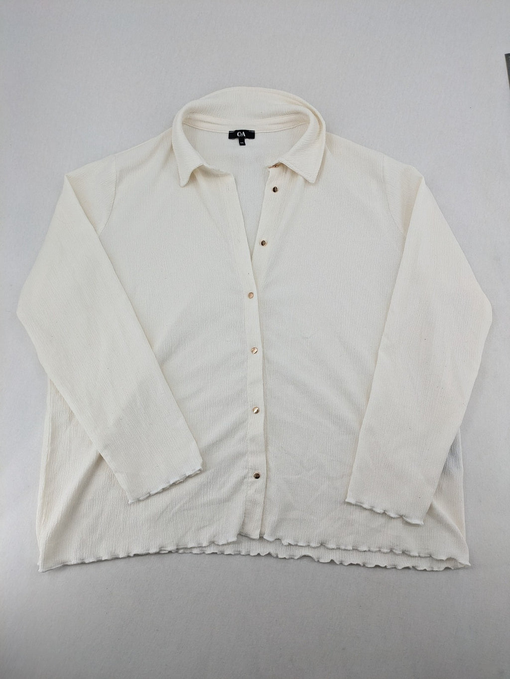 C&A cream blouse XXL textured crinkle fabric with gold button placket and wavy hem.