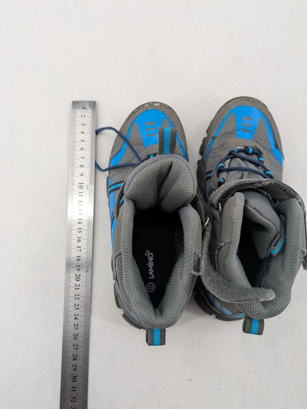 Outdoor grey and blue winter boots with high shaft, Velcro closure, and textured sole.