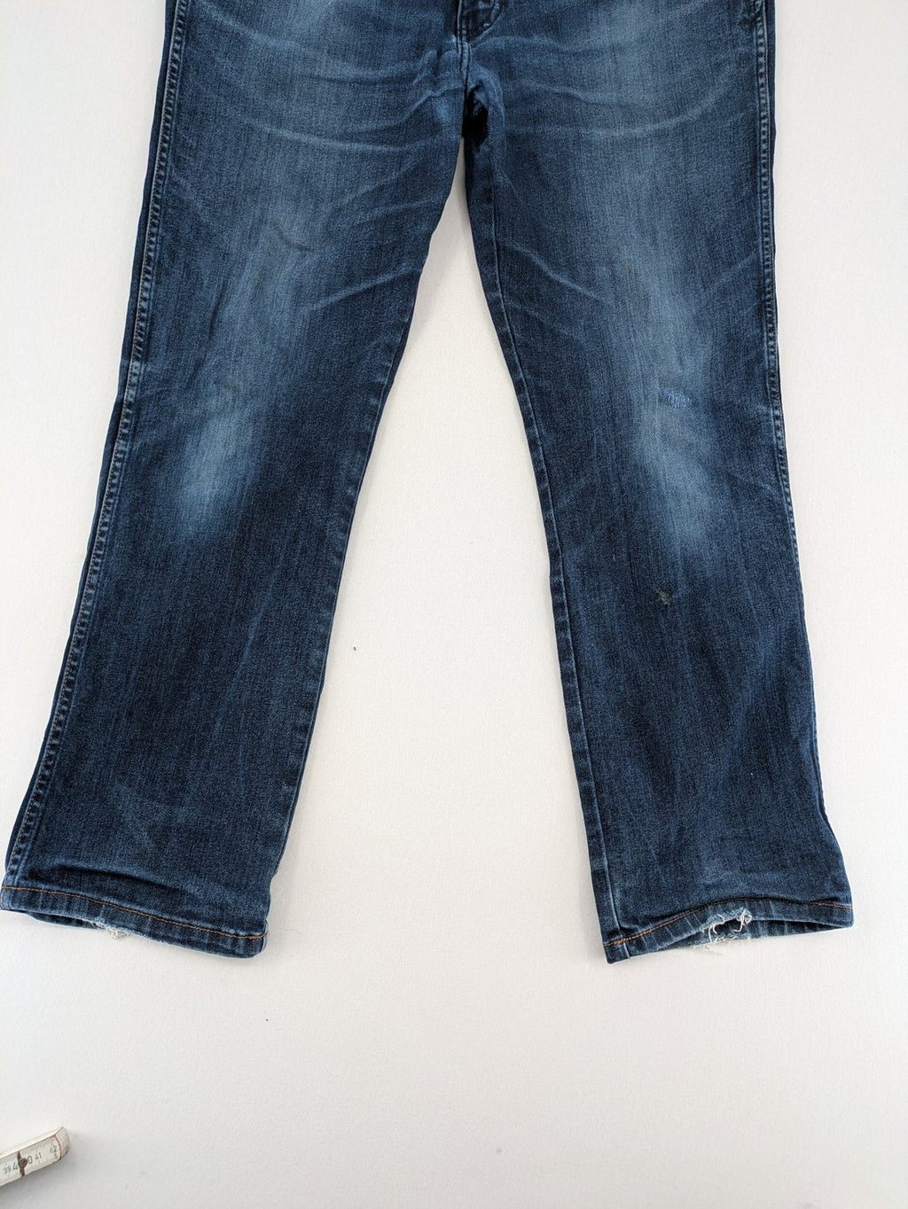 Wrangler straight jeans blue with iconic "W" stitching on back pockets.