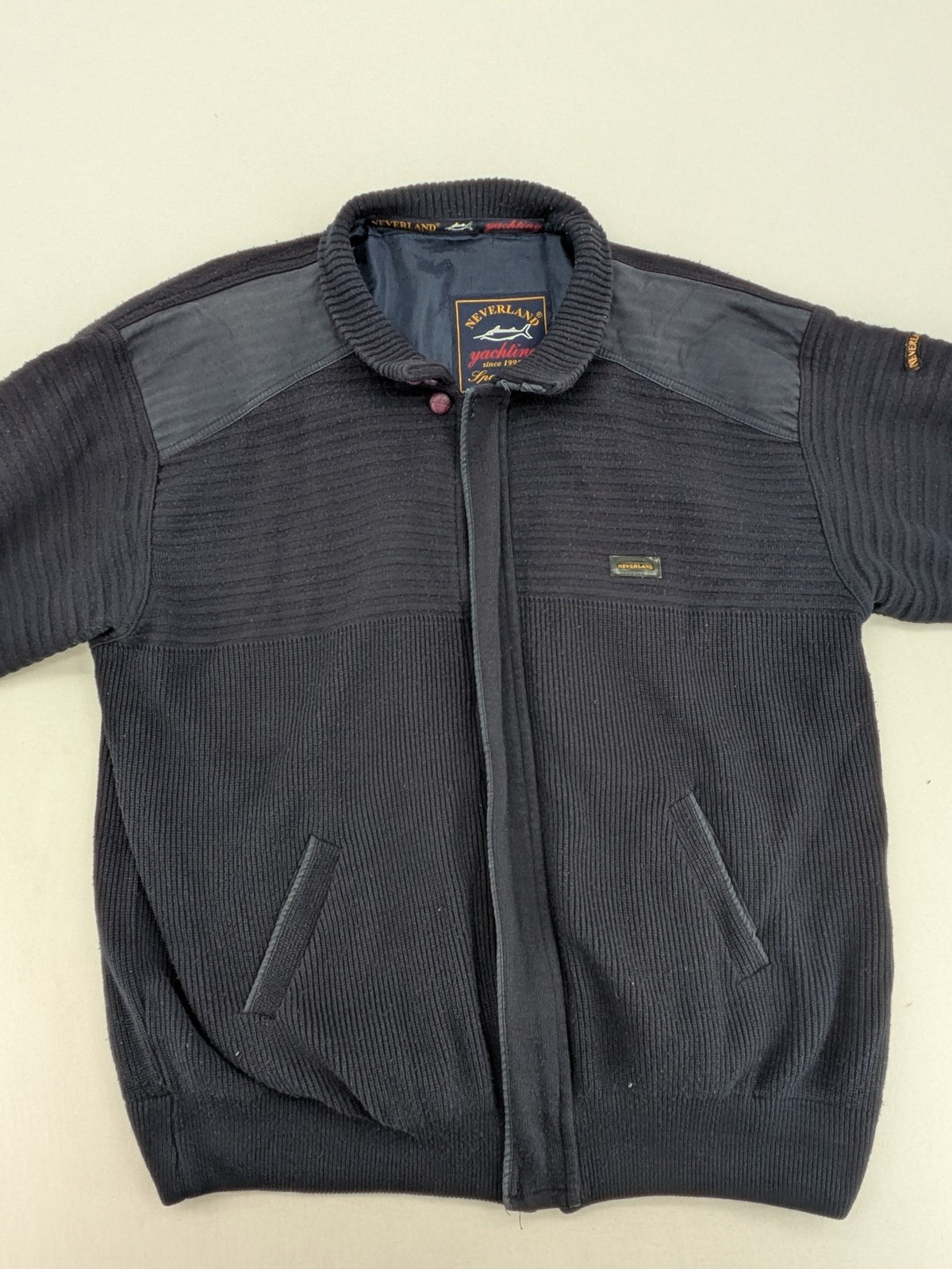 Neverland grey and navy full zip turtle neck jumper with ribbed knit and shoulder patches.
