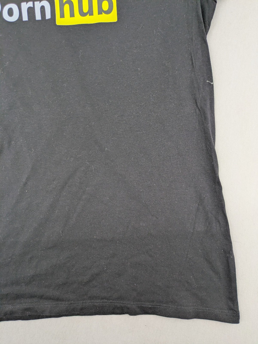 Primark black graphic t-shirt featuring yellow and white Pornhub logo on chest.