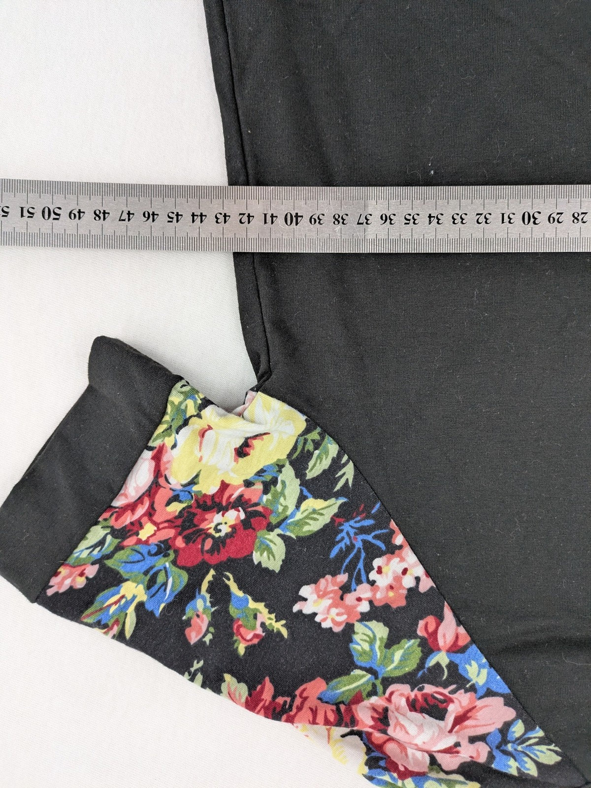 Emery Rose pink T-shirt with floral raglan sleeves and round neckline.