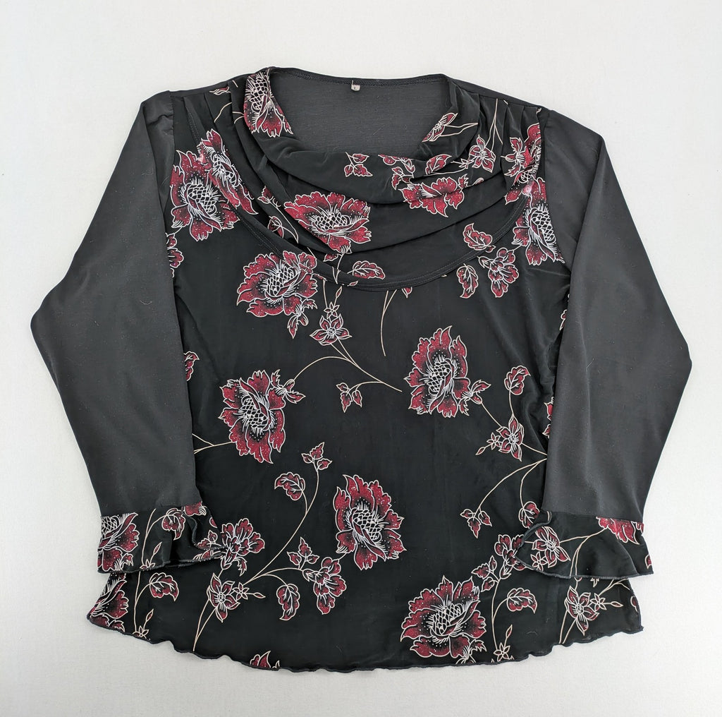Damen black top with burgundy and white floral print, waterfall collar, and ruffled sleeves.