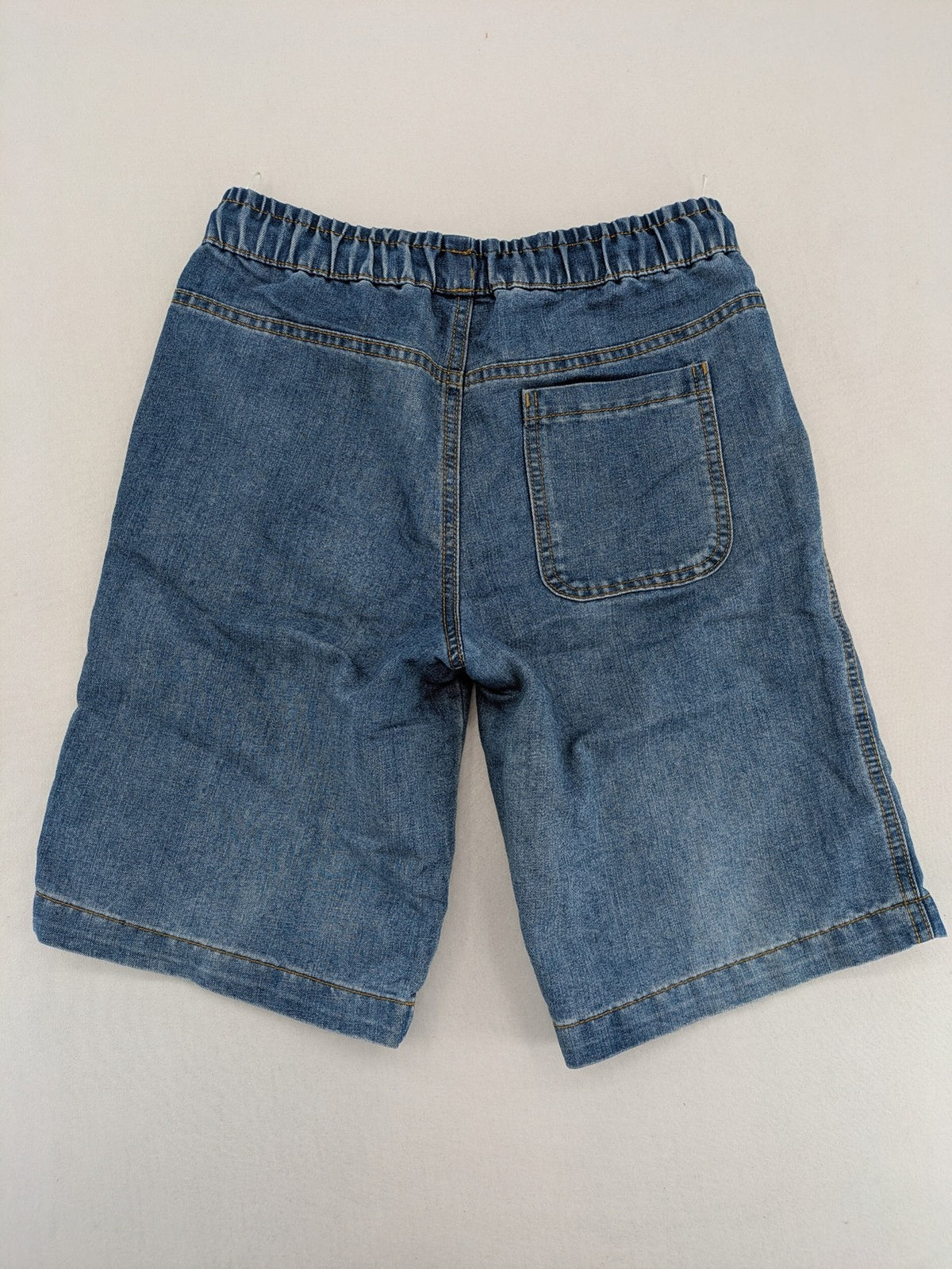 C&A blue denim shorts with elastic waistband and decorative drawstring, classic style.