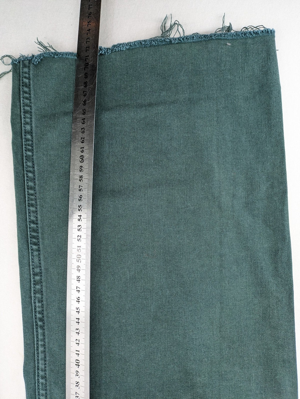 Zara green high waist wide leg jeans with frayed hem and button closure.