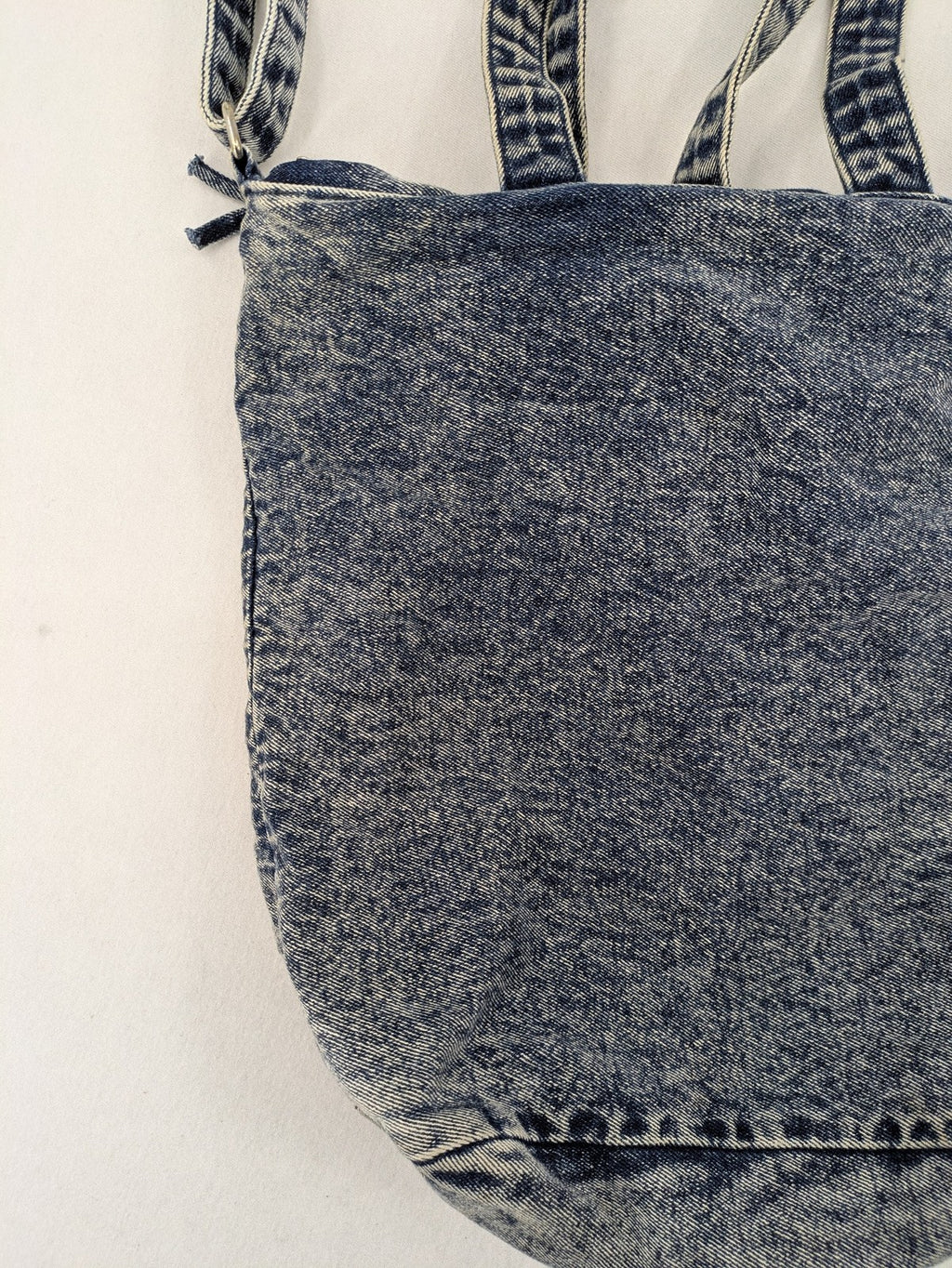 Clockhouse blue acid wash denim tote bag with adjustable shoulder strap and classic handles.