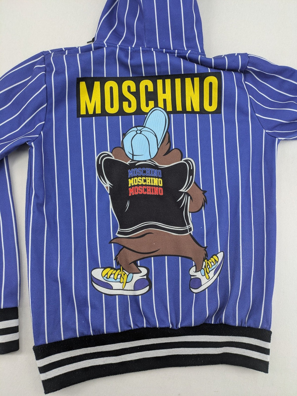 Moschino multi turtle neck jumper blue and white striped with Tasmanian Devil graphic.