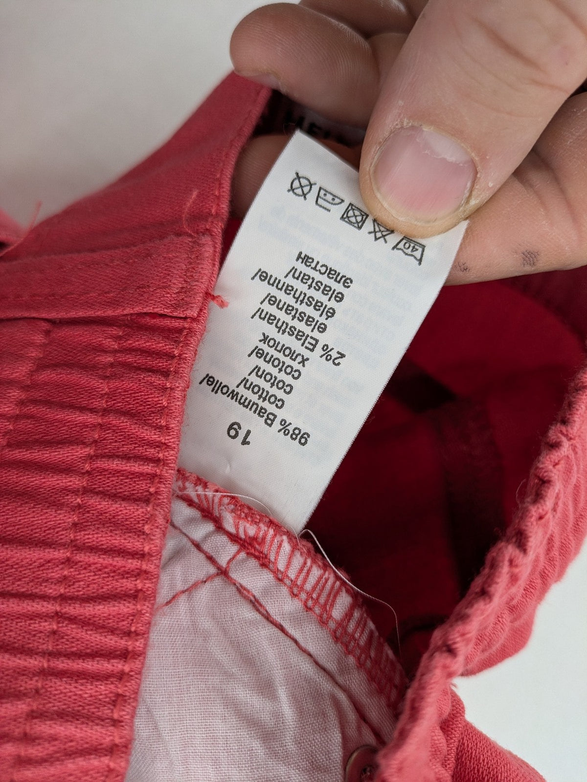 Helena Vera red straight jeans with elastic waistband and rhinestone details on pockets.
