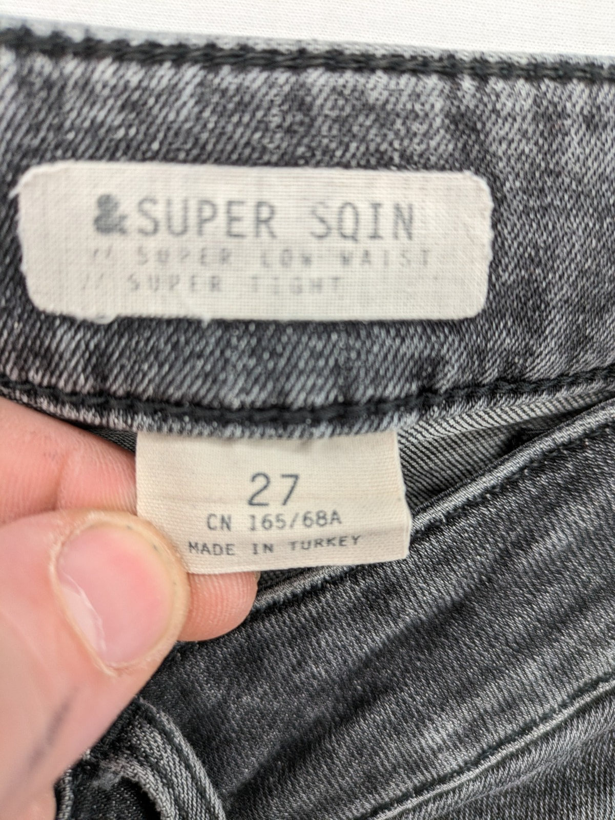 H&M grey skinny jeans with low rise, classic 5-pocket style, and washed denim finish.