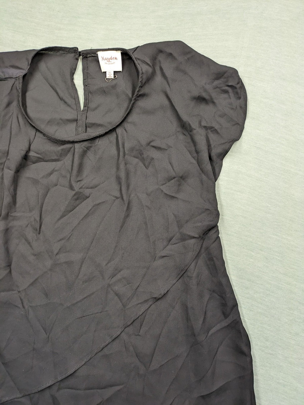 Hayden pink top asymmetrical layered design with ruffle detail, made of 100% polyester.