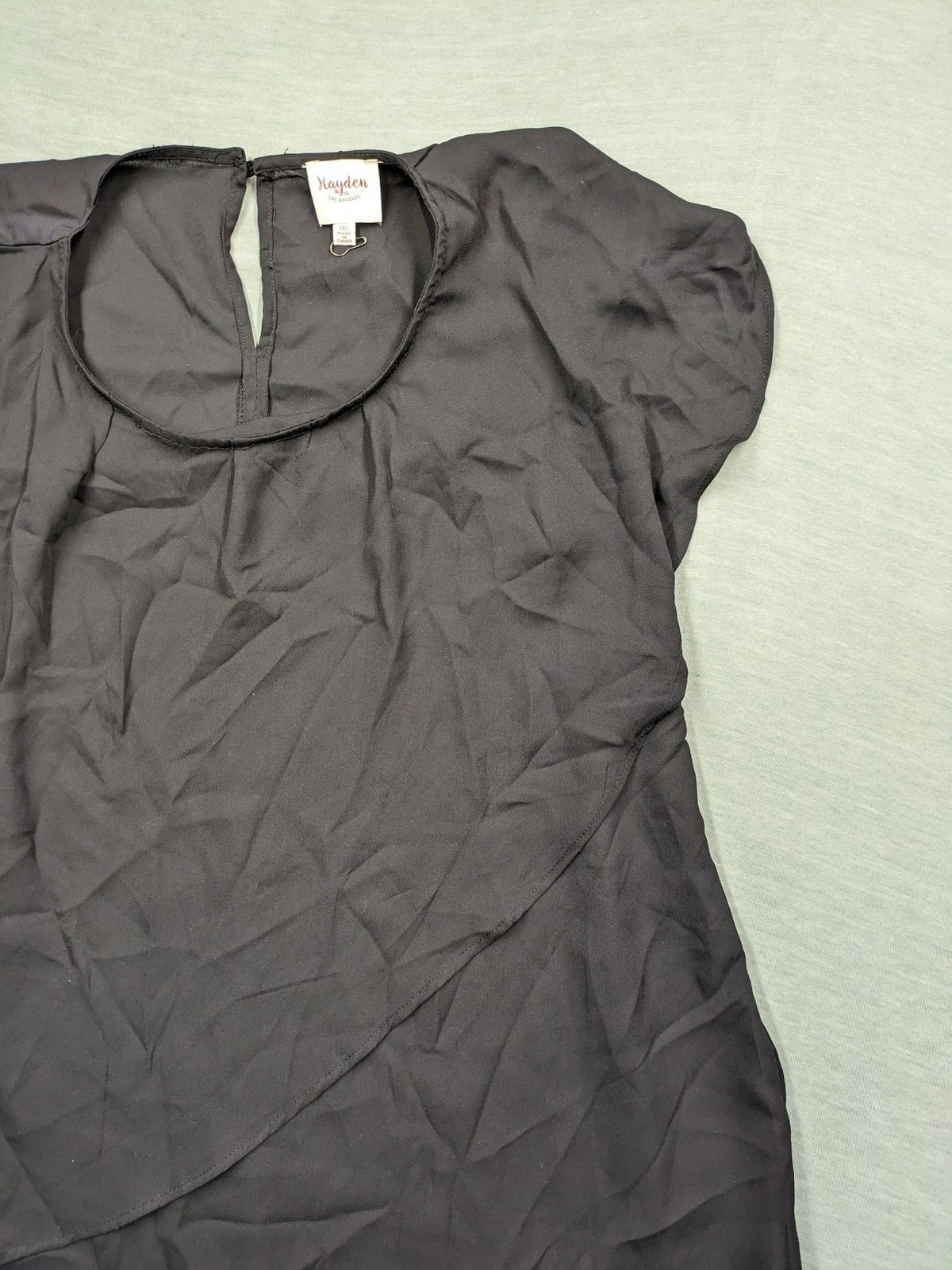 Hayden pink top asymmetrical layered design with ruffle detail, made of 100% polyester.