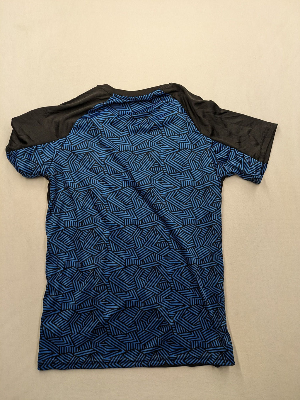 Puma black performance T-shirt with blue geometric side panels and iconic logo.