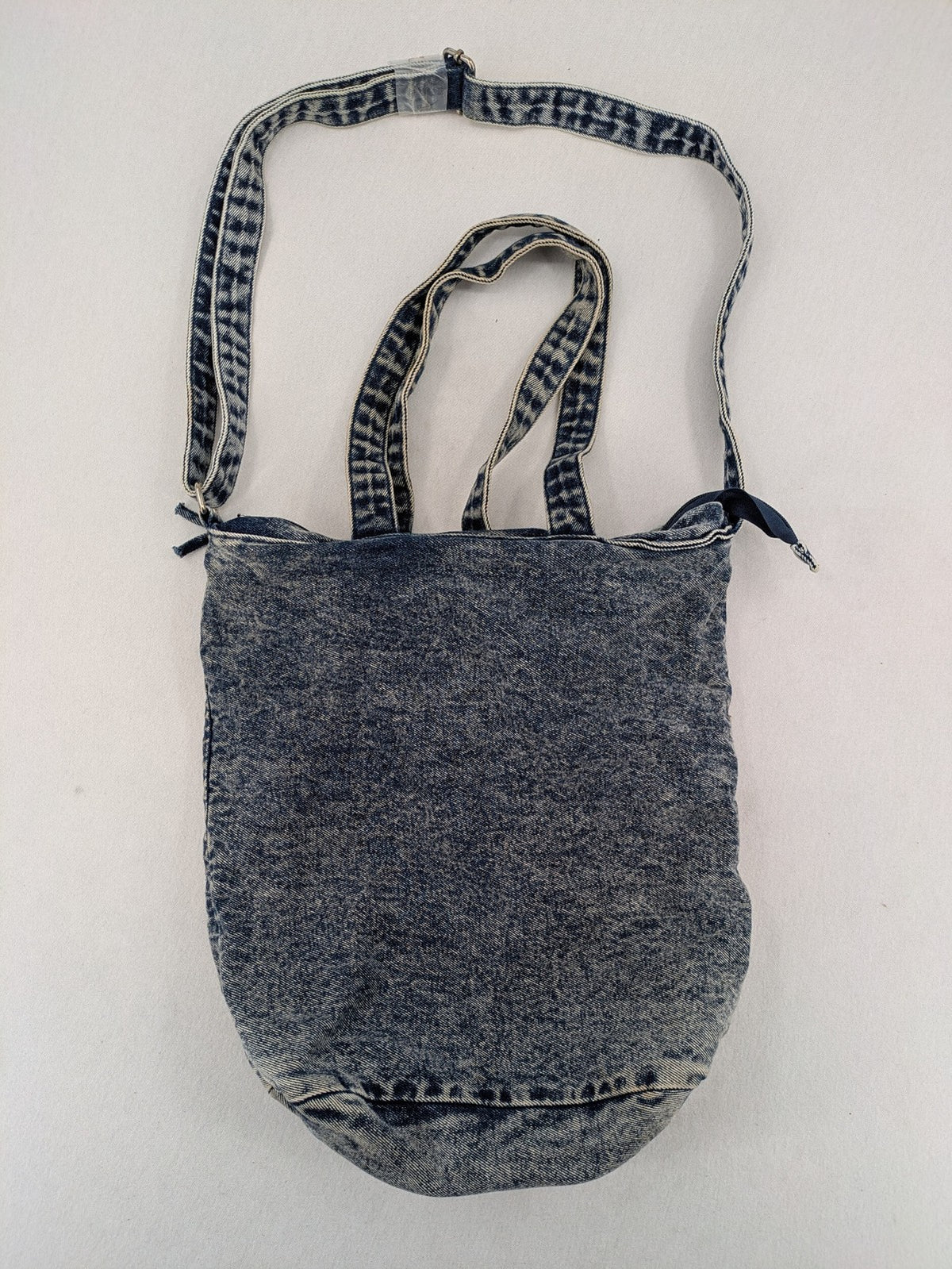 Clockhouse blue acid wash denim tote bag with adjustable shoulder strap and classic handles.