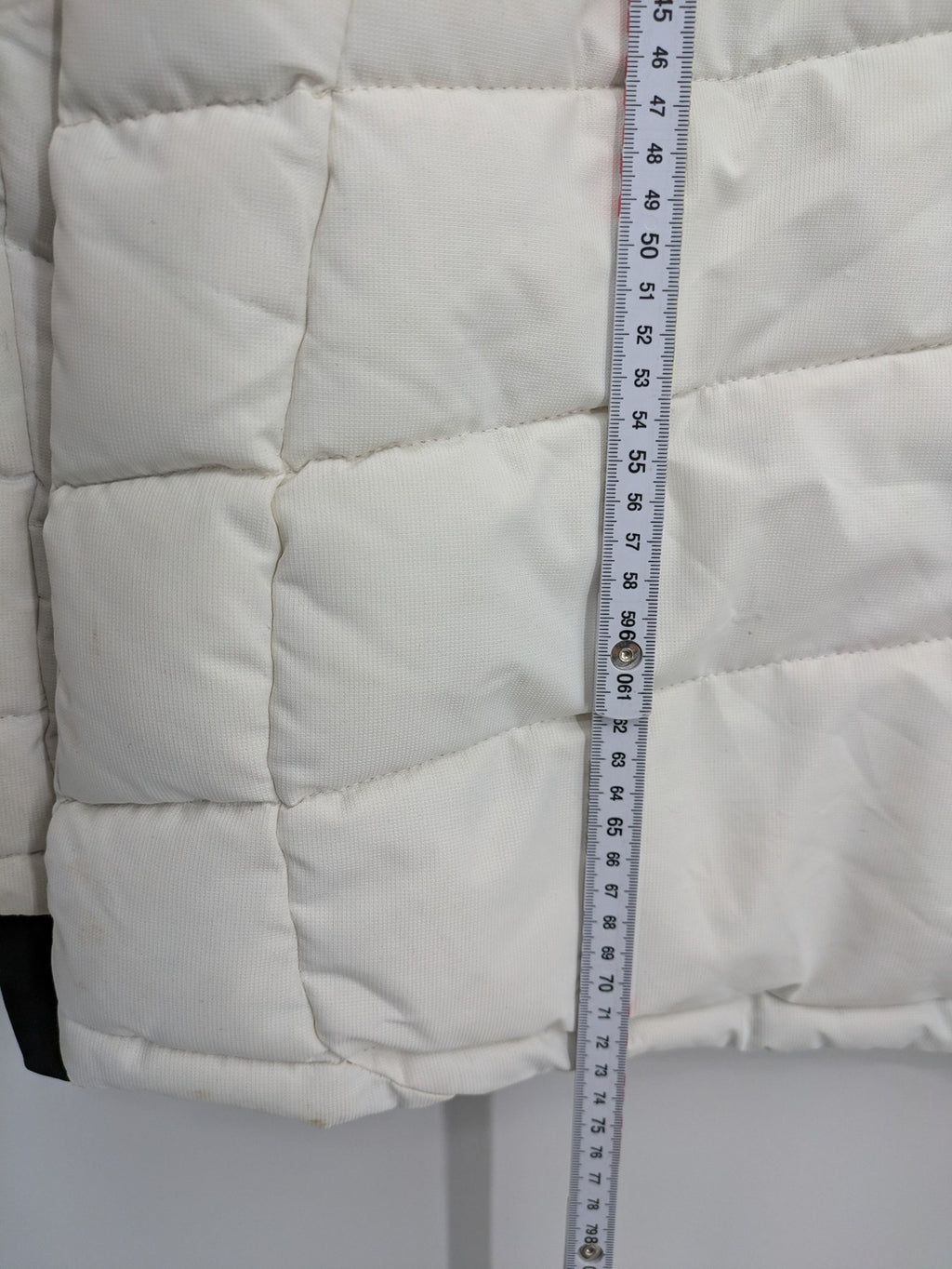 Janina white puffer jacket with quilted design and faux fur hood accents.