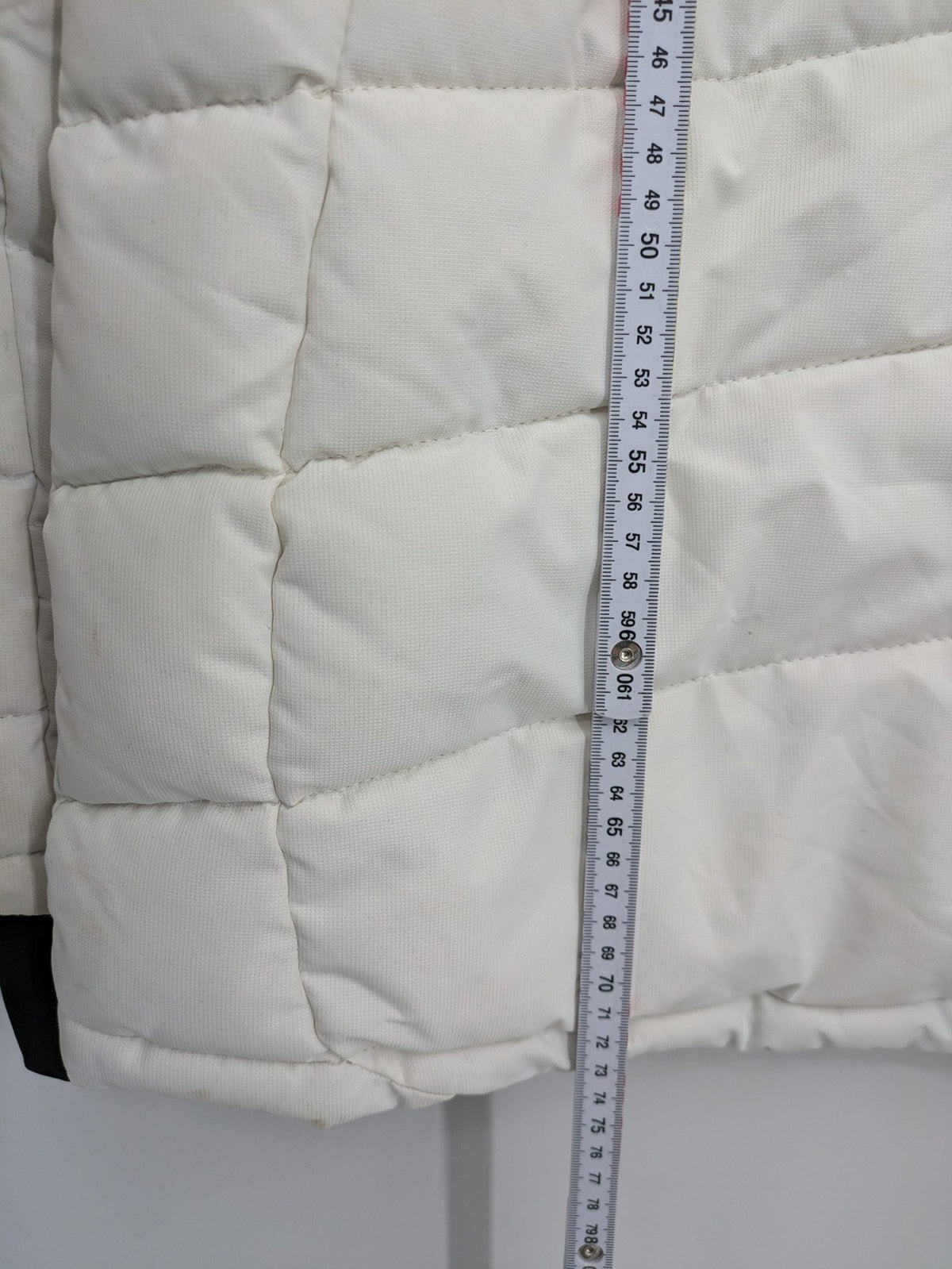 Janina white puffer jacket with quilted design and faux fur hood accents.