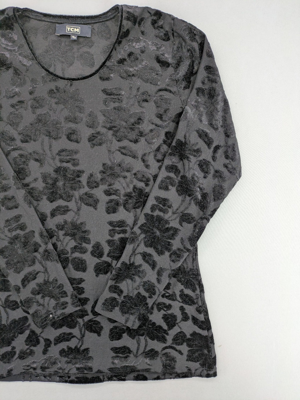 TCM black long sleeve top with floral flock print on sheer fabric.