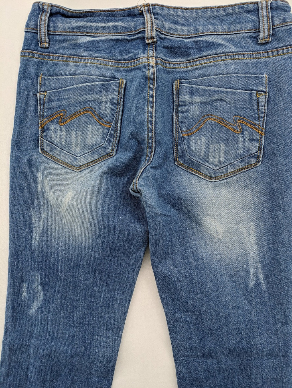 Denim blue straight jeans low rise bootcut with classic 5-pocket design and subtle rivets.