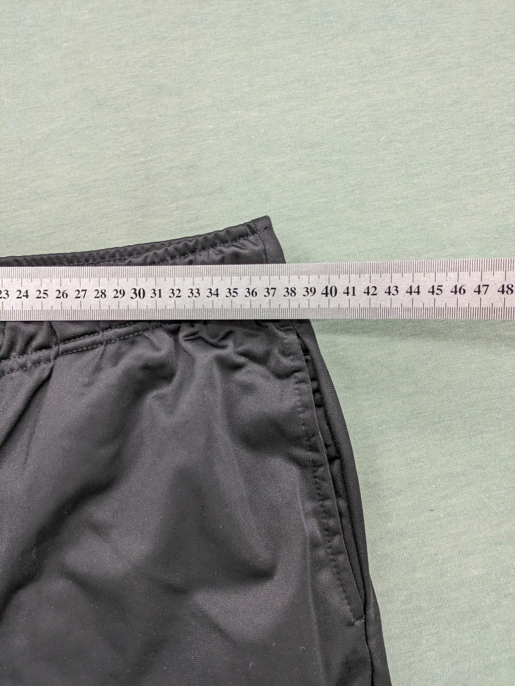 Crivit black weighted training pants with elastic waistband, side pockets, and zippered cuffs.