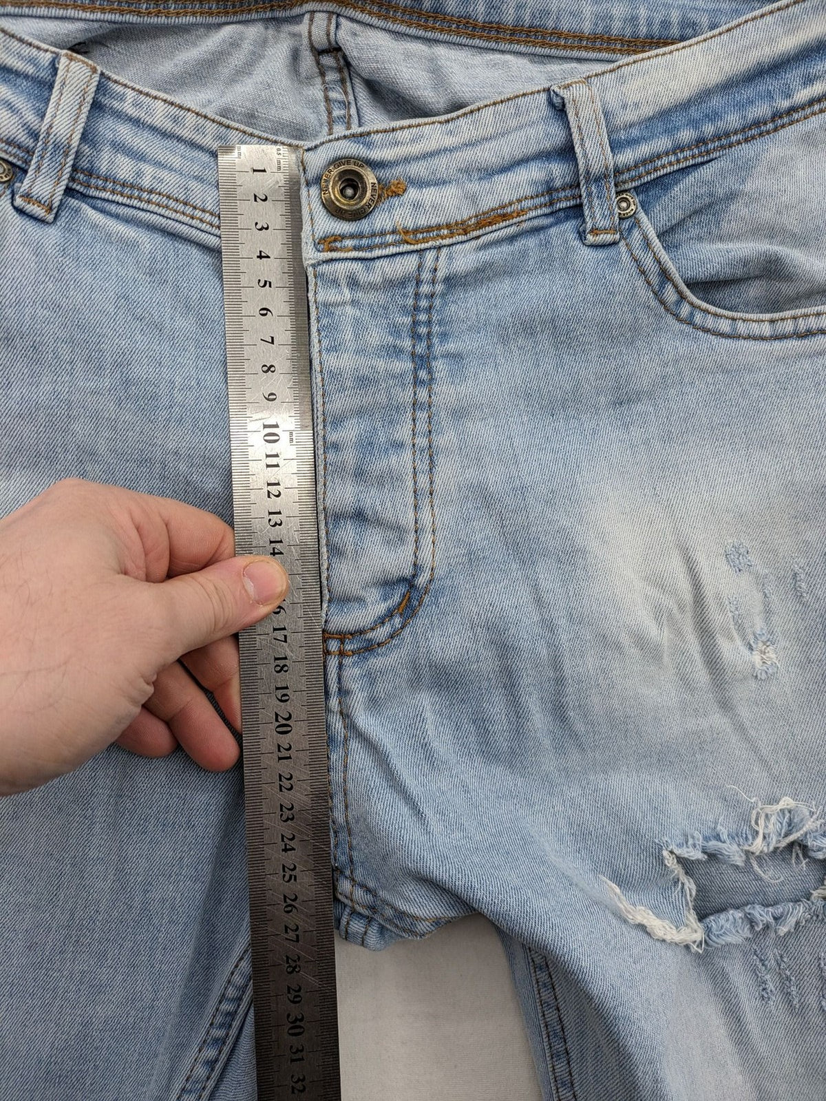i8 Denim blue straight jeans destroyed look with frayed hems and classic button fly.