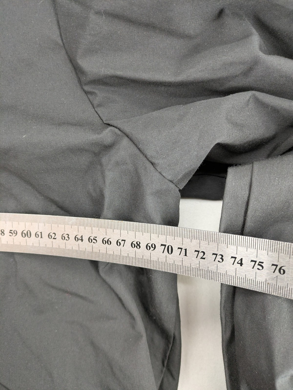Hypnotism grey windbreaker jacket with hood, snap buttons, and zip closure.