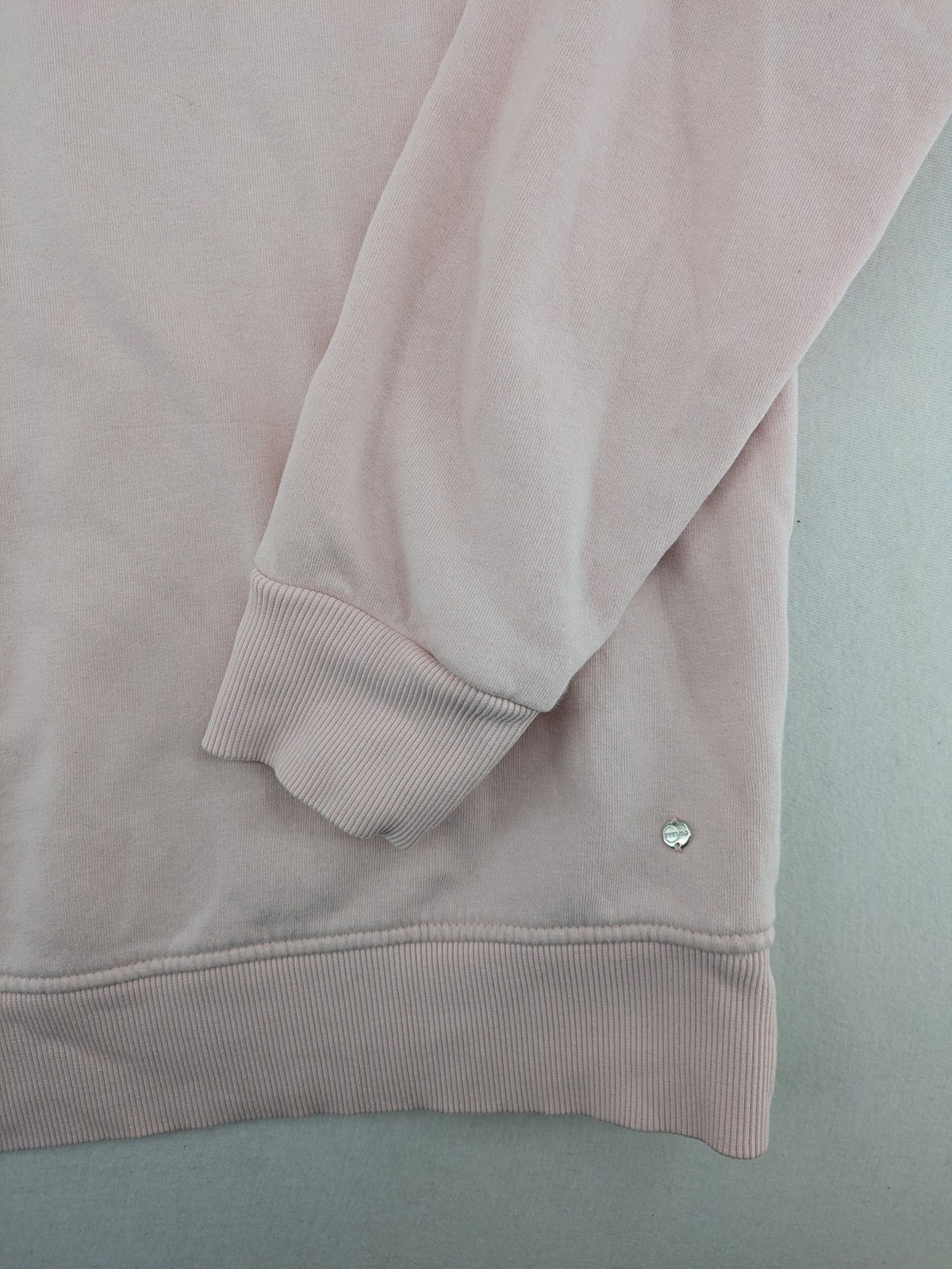 Hello Kitty pink sweatshirt classic graphic face logo on chest, long sleeves, round neck.