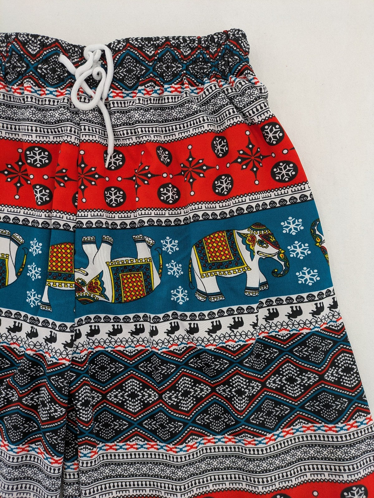 Elefanten multi shorts featuring vibrant elephant and geometric patterns with elastic waistband.