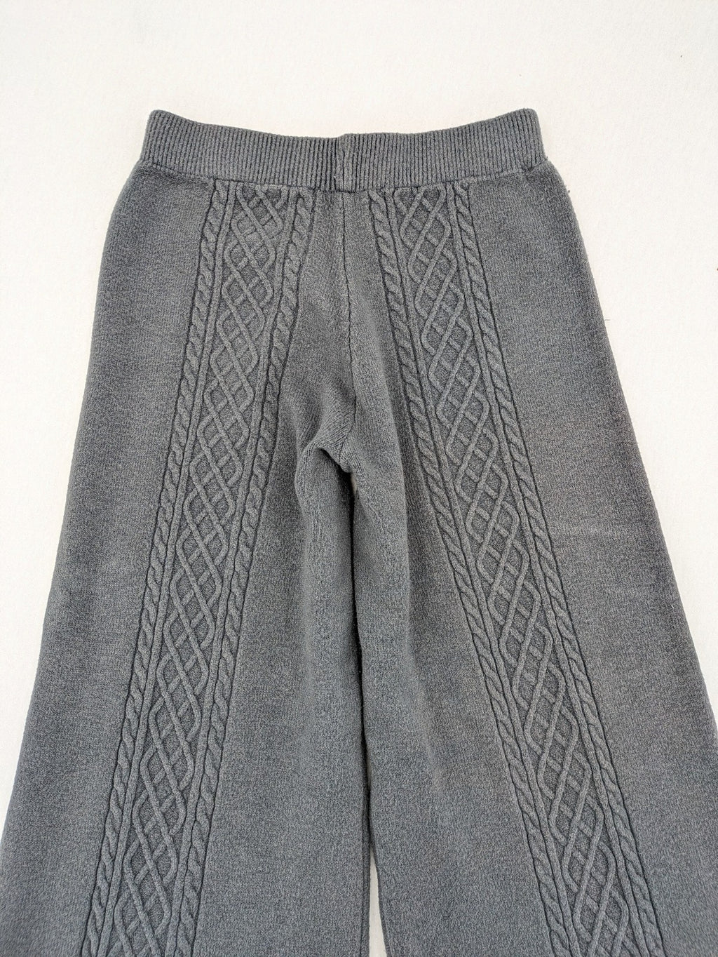 Grey pants with cable knit pattern, wide leg, ribbed waistband, 100% polyester.