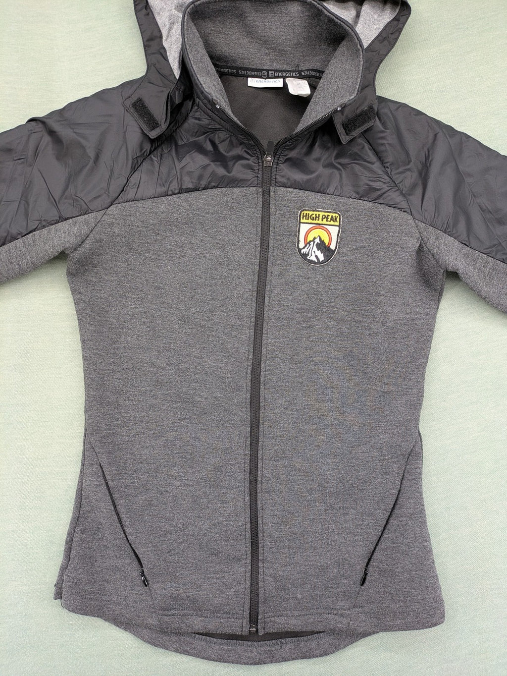 Energetics hybrid jacket black grey with High Peak patch and zip-up design.