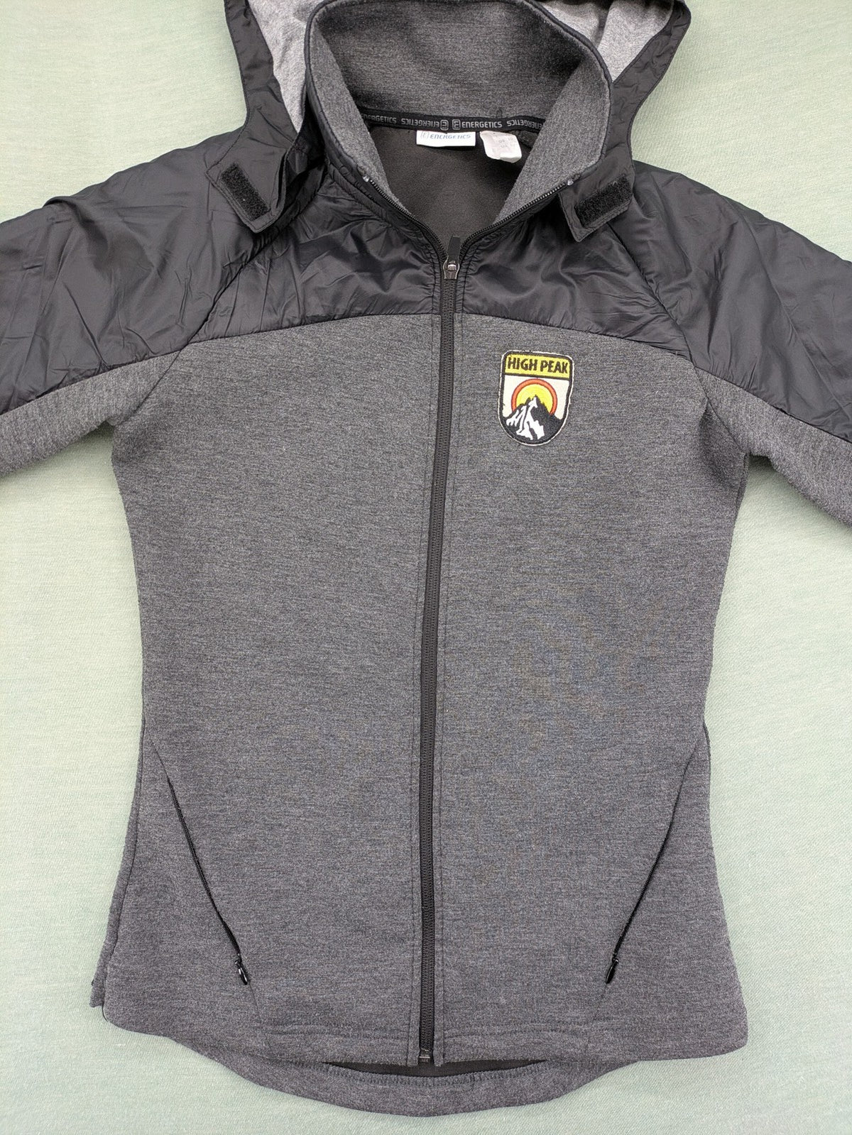 Energetics hybrid jacket black grey with High Peak patch and zip-up design.