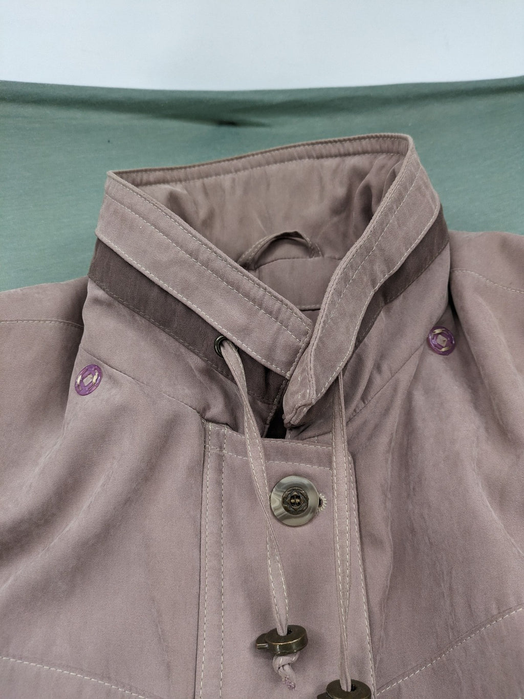 Goldix beige coat with checkered lining and Sympatex waterproof technology.