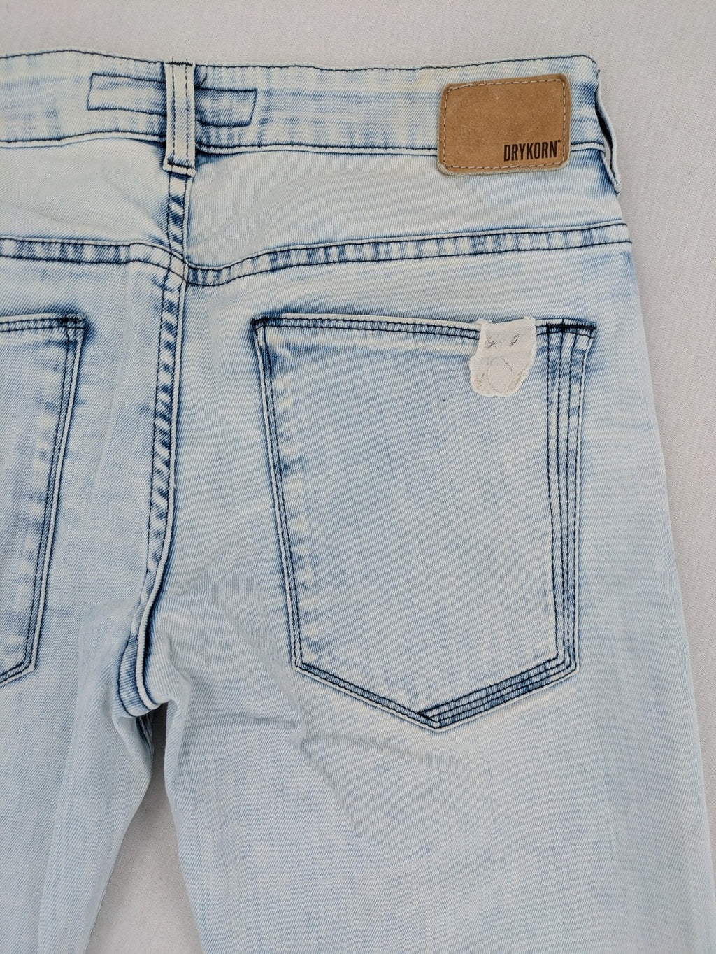 Drykorn blue slim fit jeans with acid wash and leather logo patch.