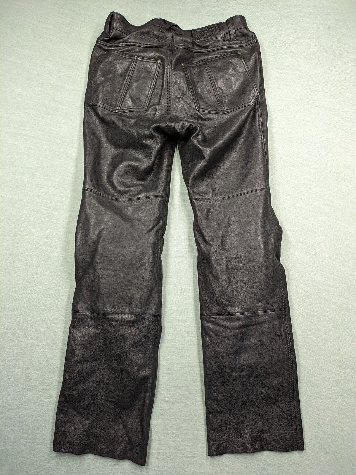 Spirit Motors black leather chaps with red and white accents, 5-pocket style, reinforced knees.