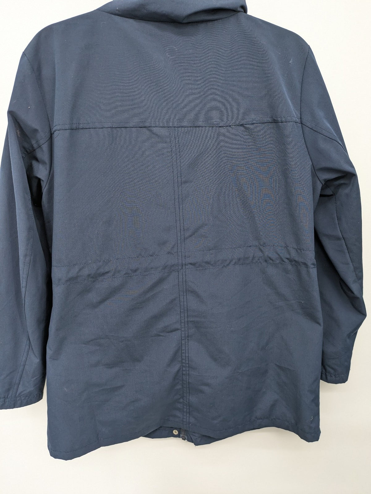 Janina navy anorak jacket with high collar and adjustable drawstring waist.