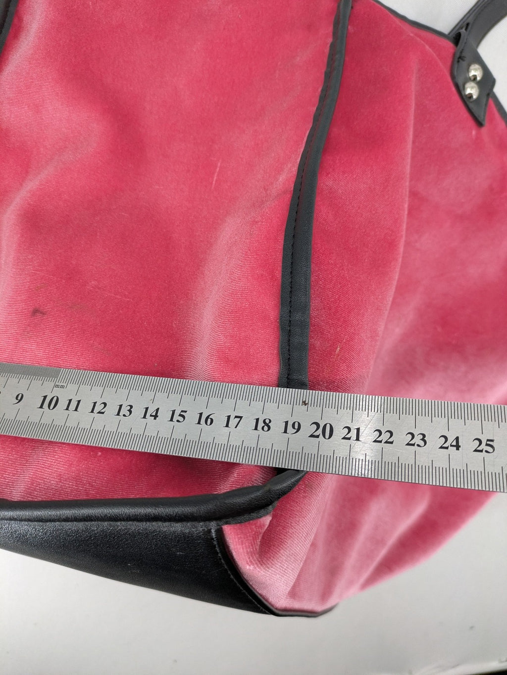 Juicy Couture pink velour handbag with oversized black logo and faux leather straps.