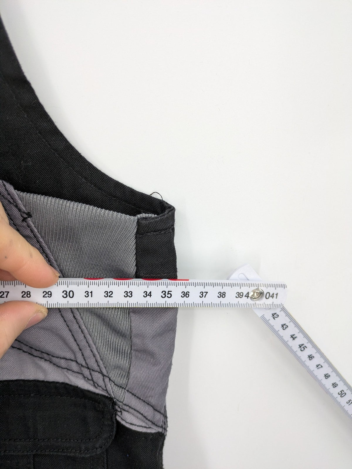 Cargo pants black grey two-tone design with red stitching and multiple pockets