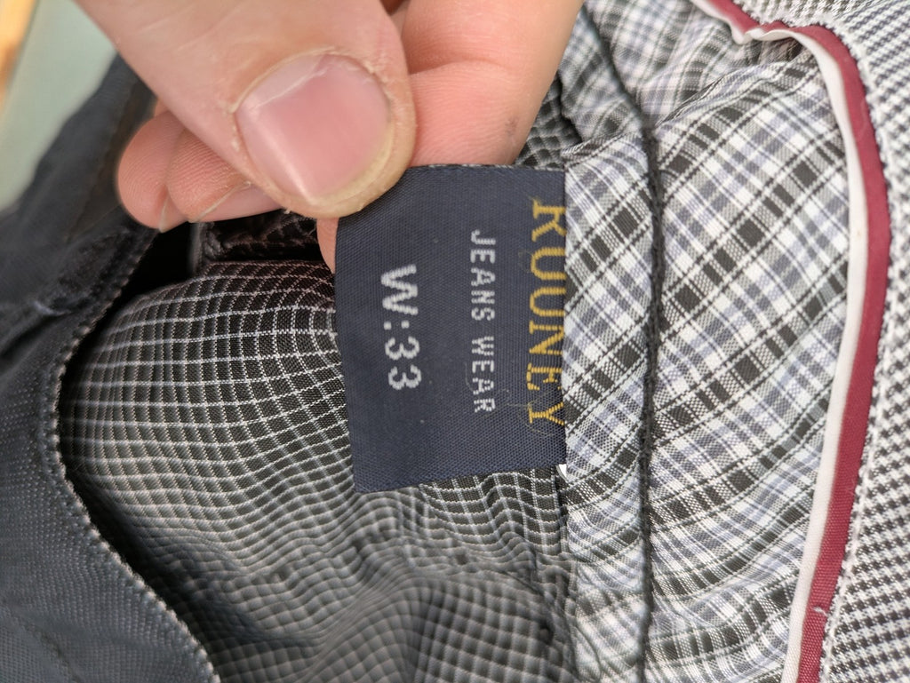 Rooney grey chino pants with checkered waistband and buttoned back pockets.