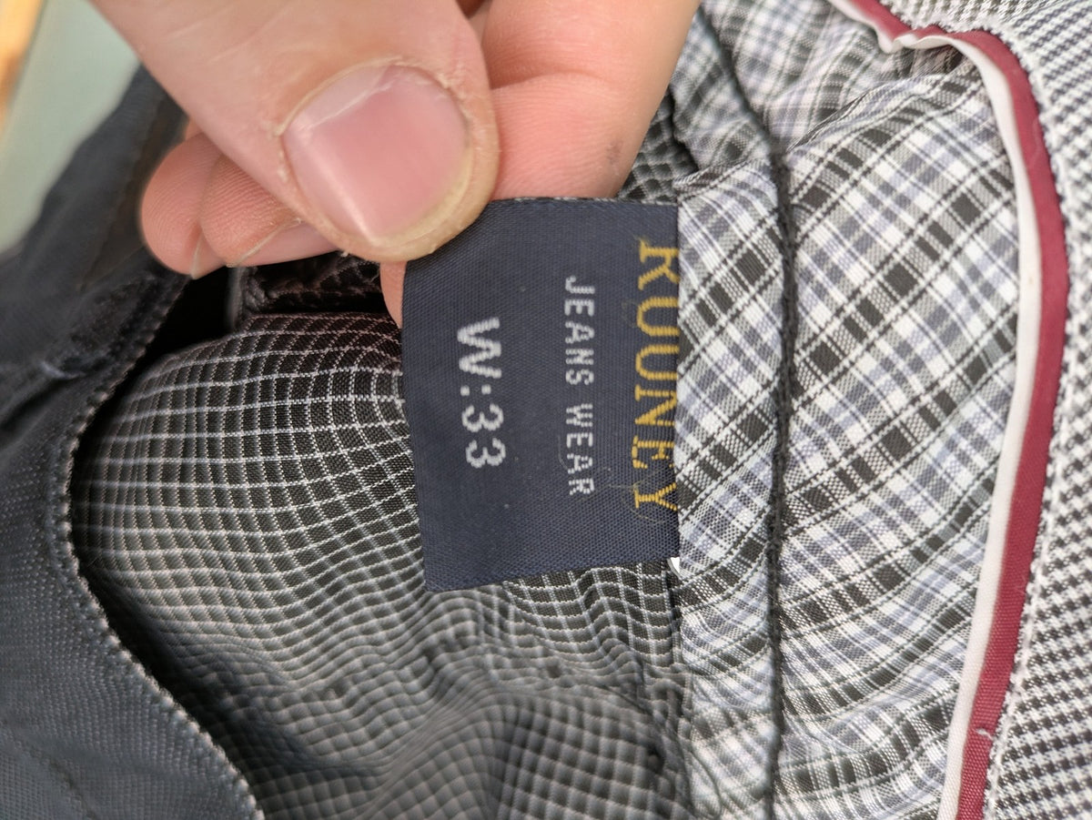 Rooney grey chino pants with checkered waistband and buttoned back pockets.