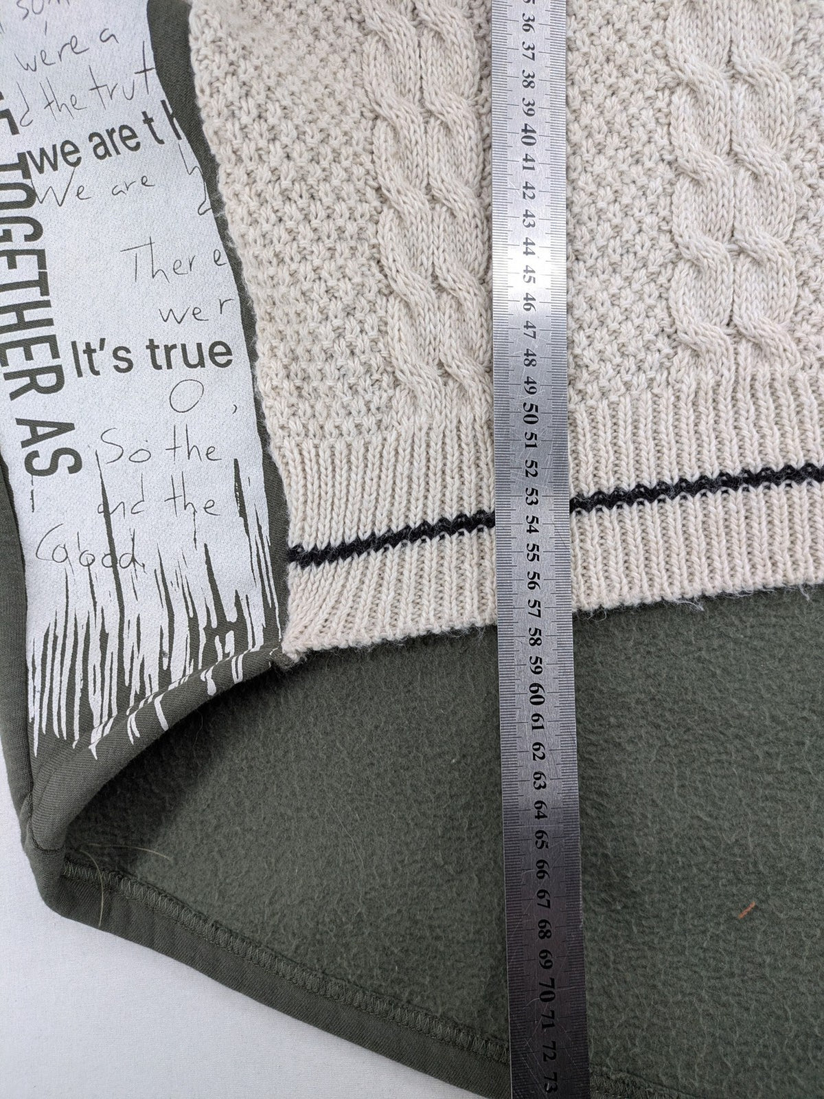 DCJ cream and olive green hoodie with cable knit pattern and graphic text sleeves.