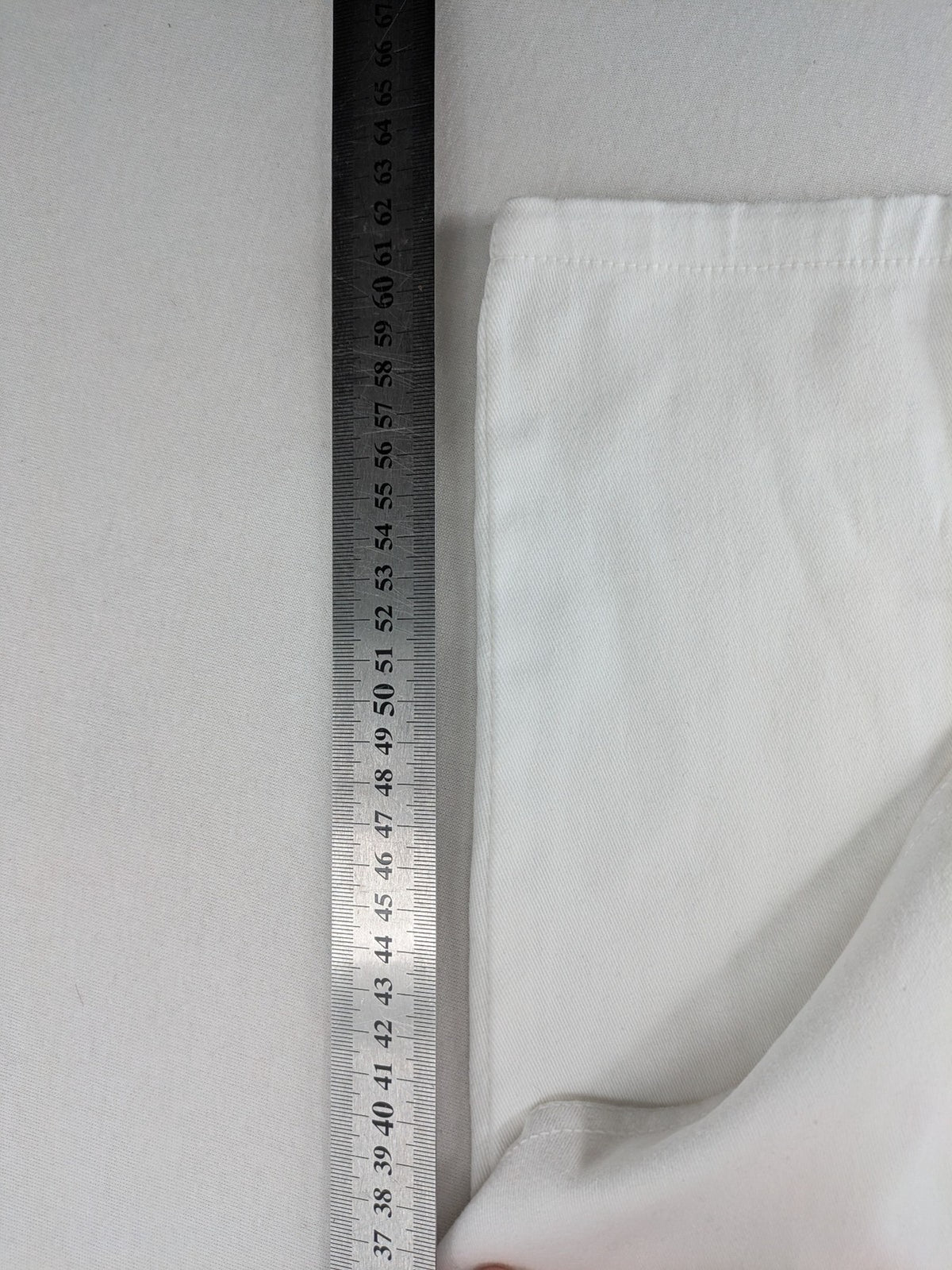 New Collection white straight jeans asymmetrical wrap design with side lacing and cotton-stretch material.