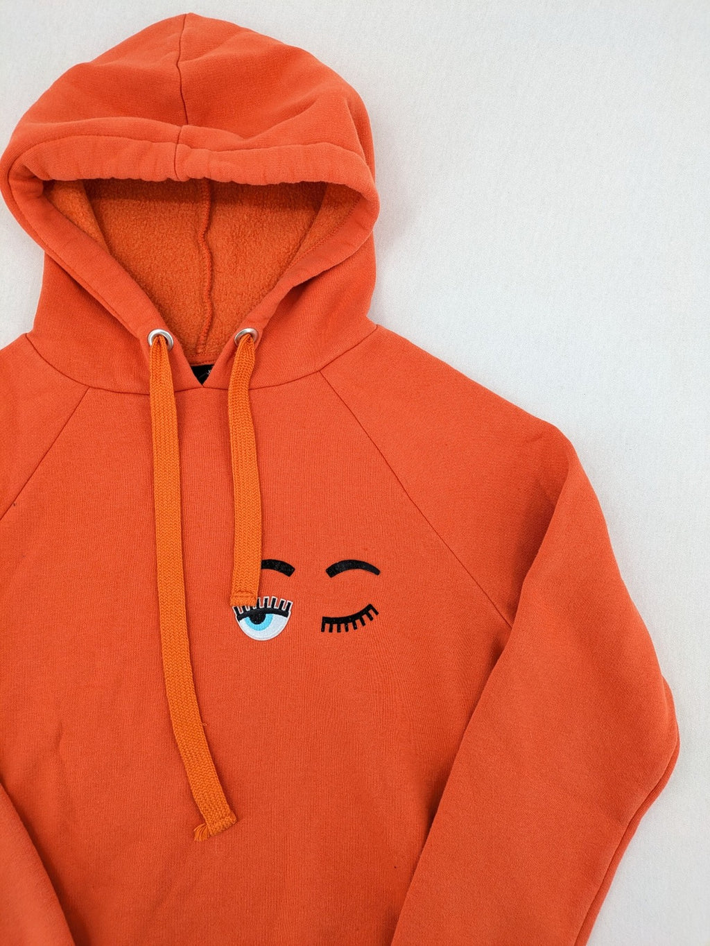 Ginatricot orange hoodie with embroidered winking eye detail, soft material, classic fit.