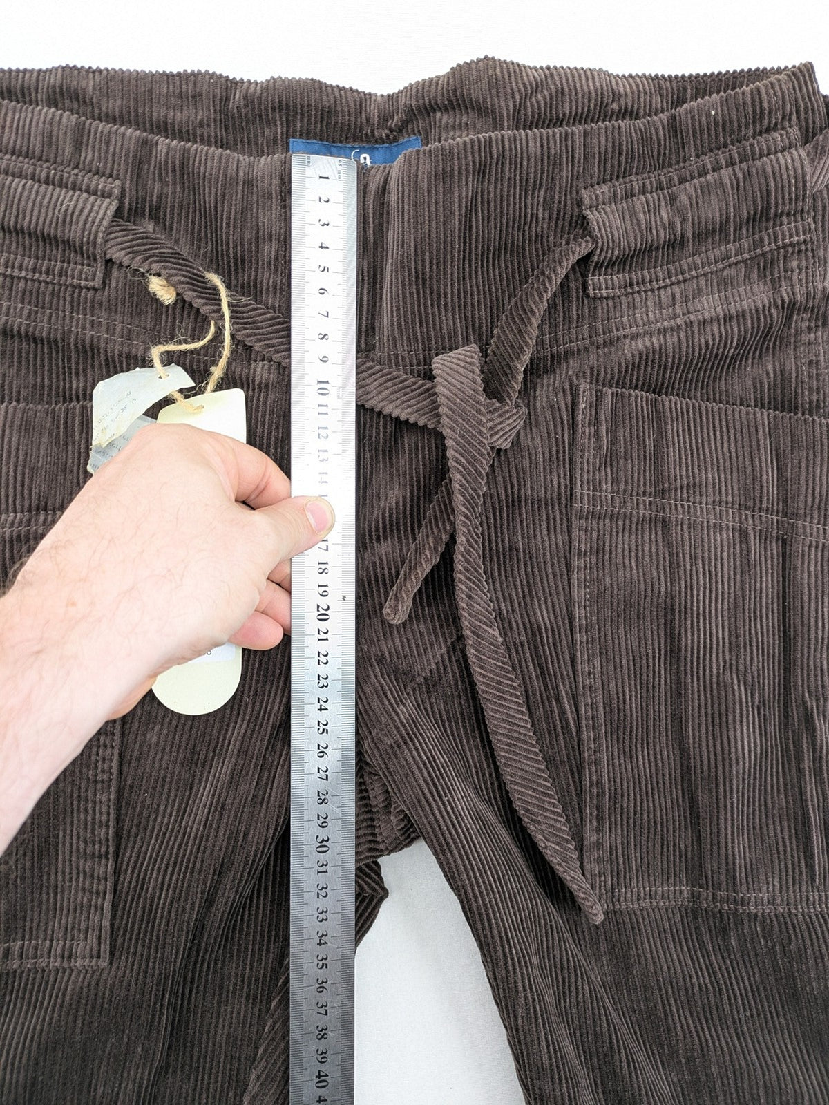 Alma & Lovis cream cord pants high-waist with matching belt and front pockets.
