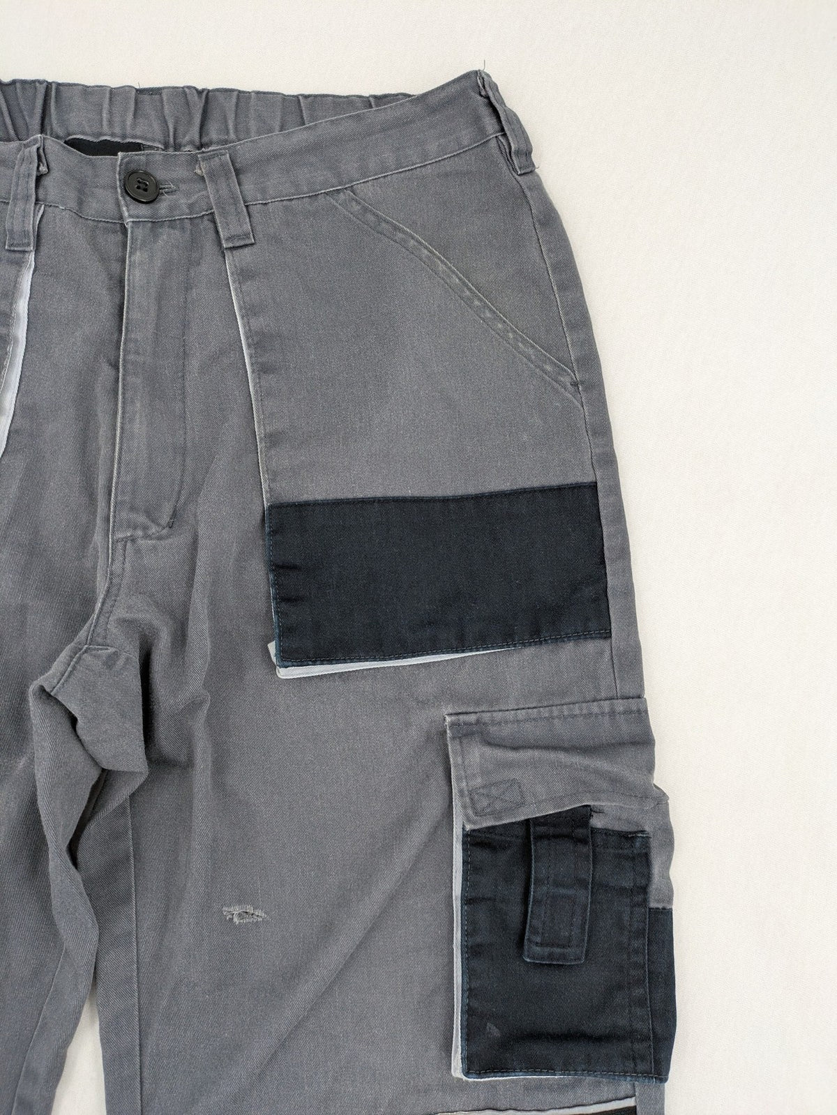 Watsons grey and black hunting tactical pants with Cordura reinforcements and elastic waistband.