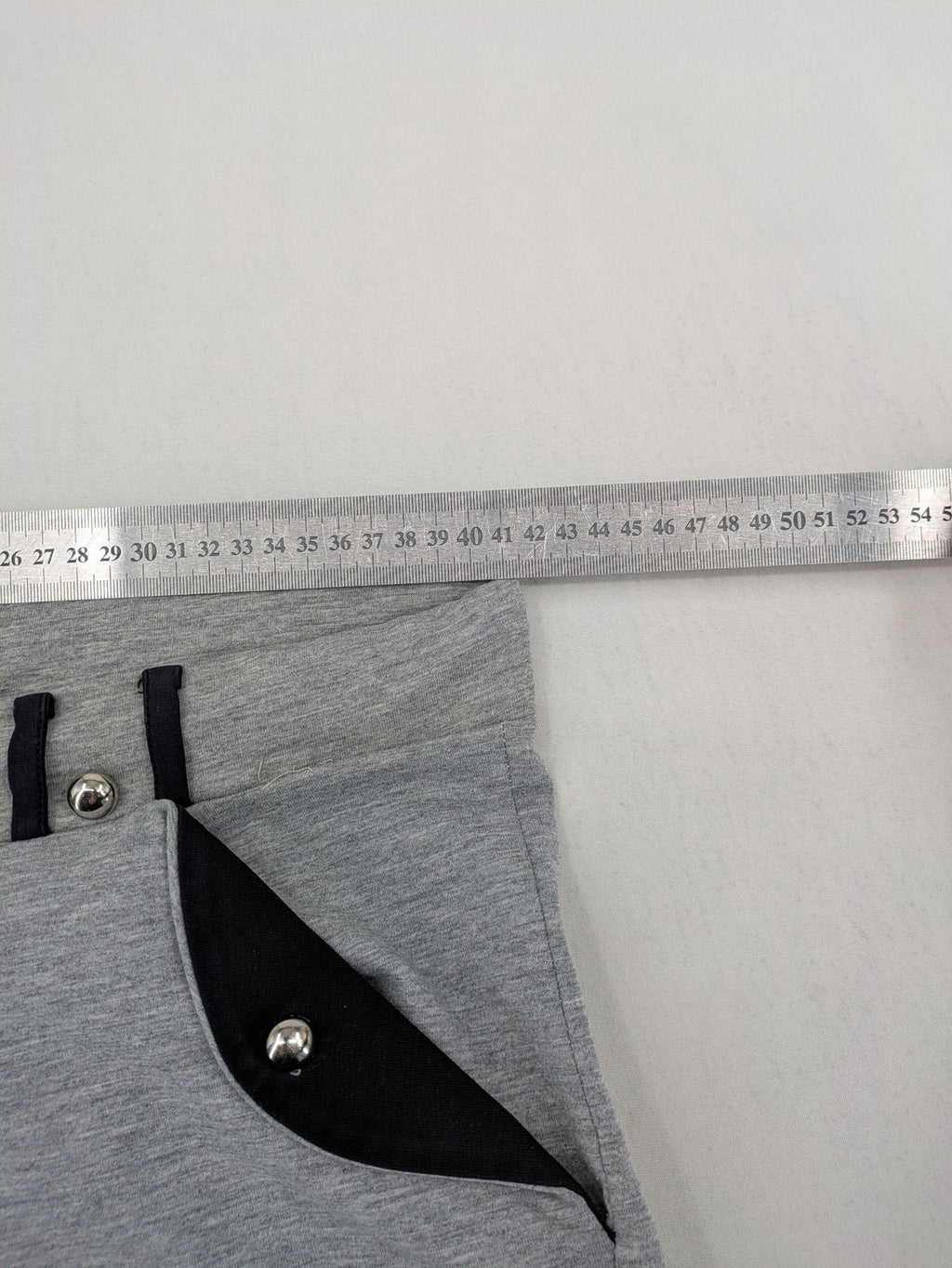 Falconhill grey jogging pants with elastic waistband, drawstring, and stylish black accent pockets.