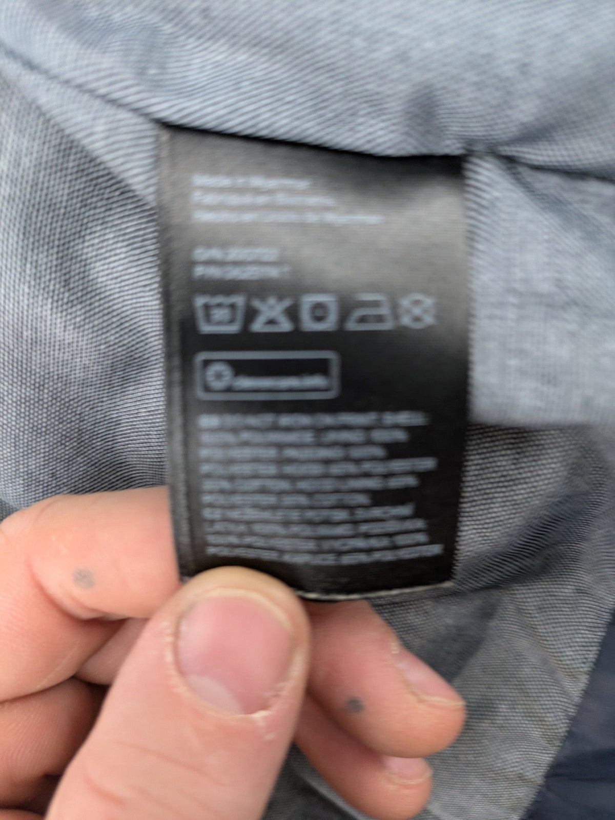 H&M navy puffer vest with grey hood and zip pockets for kids.